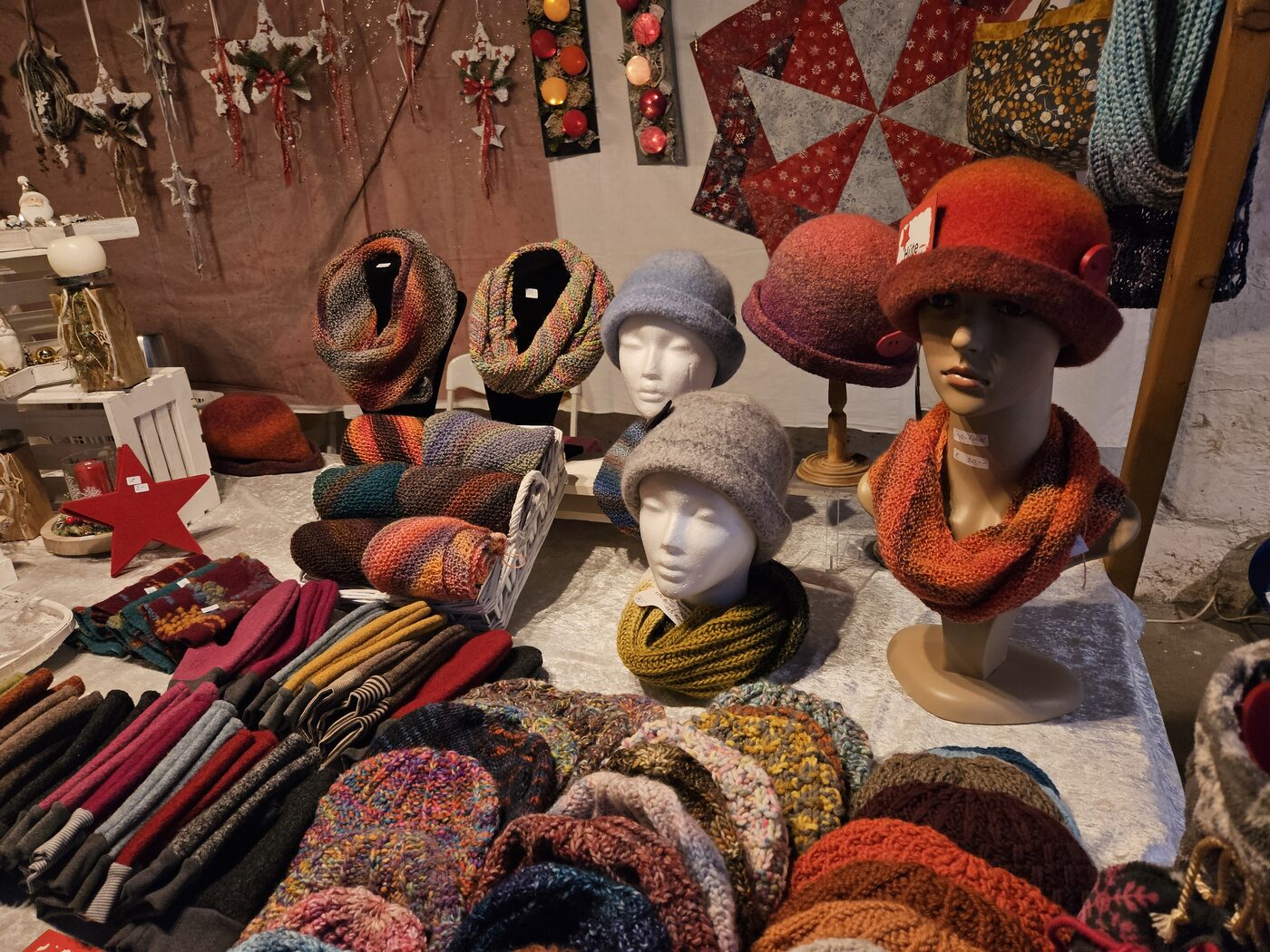 Handgestrickte Mützen, Schals und Accessoires an einem Marktstand